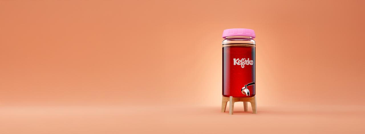 Fermentador de kombucha de vidrio Kefirko con kombucha y tapa rosa, listo para hacer kombucha casera, sobre fondo naranja.